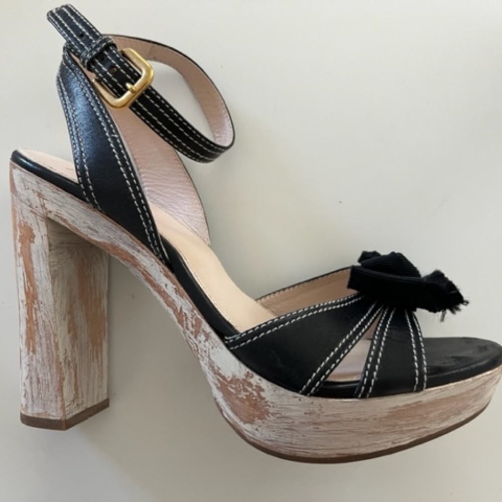 PRADA Bow distressed wooden heels.